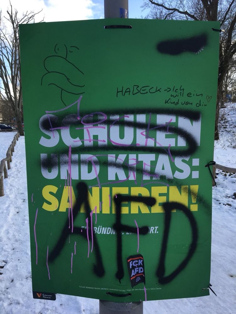 Wahlplakat der Grünen, das jemand große mit der Abkürzung AfD in schwarzer Sprühfarbe übermalt hat