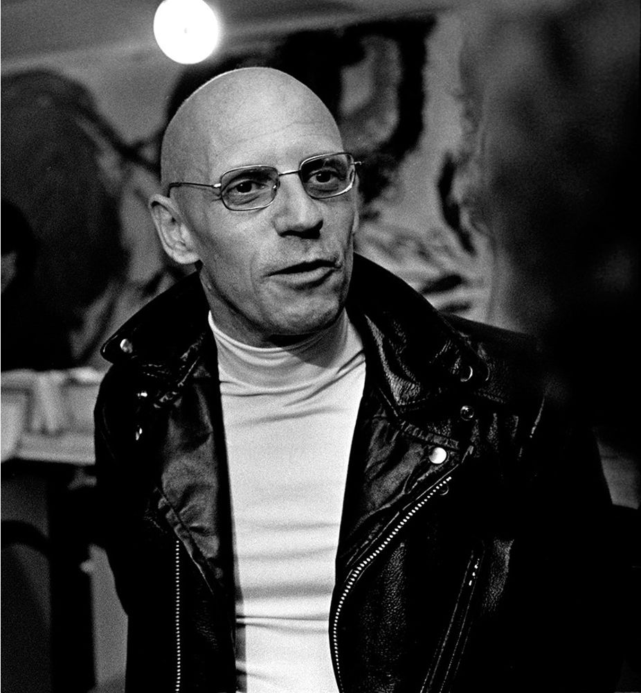 Michel Foucault in a badass biker jacket and signature turtleneck