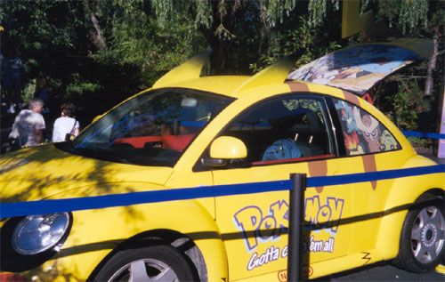 A picture of a newer Volkswagen Beatle decorated in a Pikachu theme.