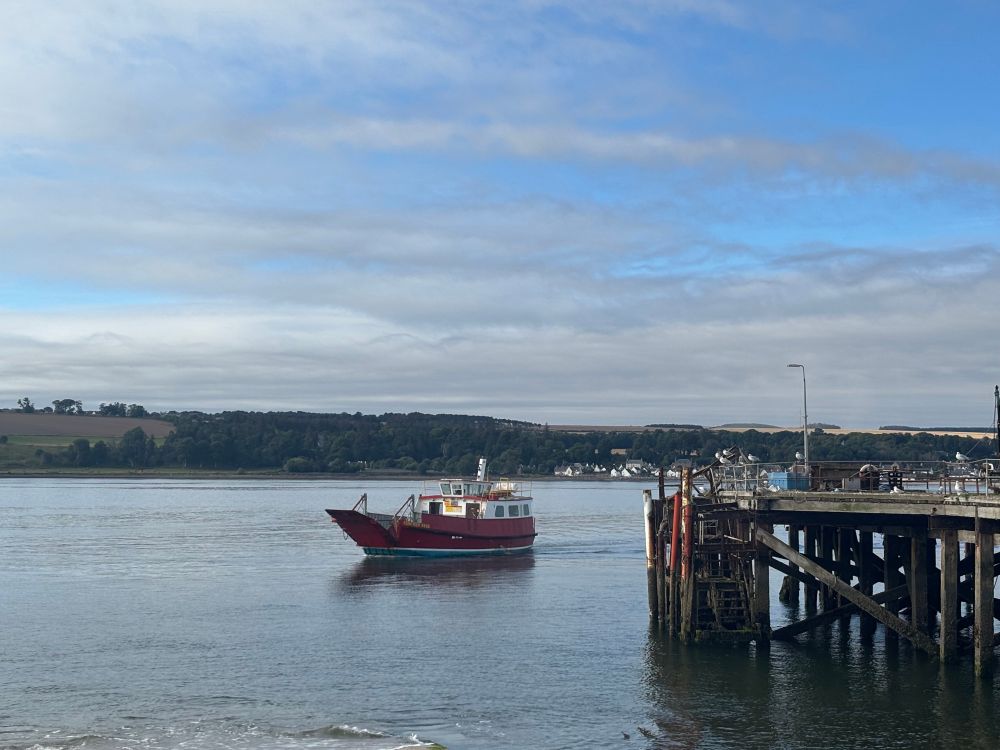 The Cromarty ferry which provides a crossing from Nigg. The ferry can take one vehicle and is seasonal only. The ferry is approaching the slipway and next to that is an old pier which is no longer in use. The crossing is 1 mile