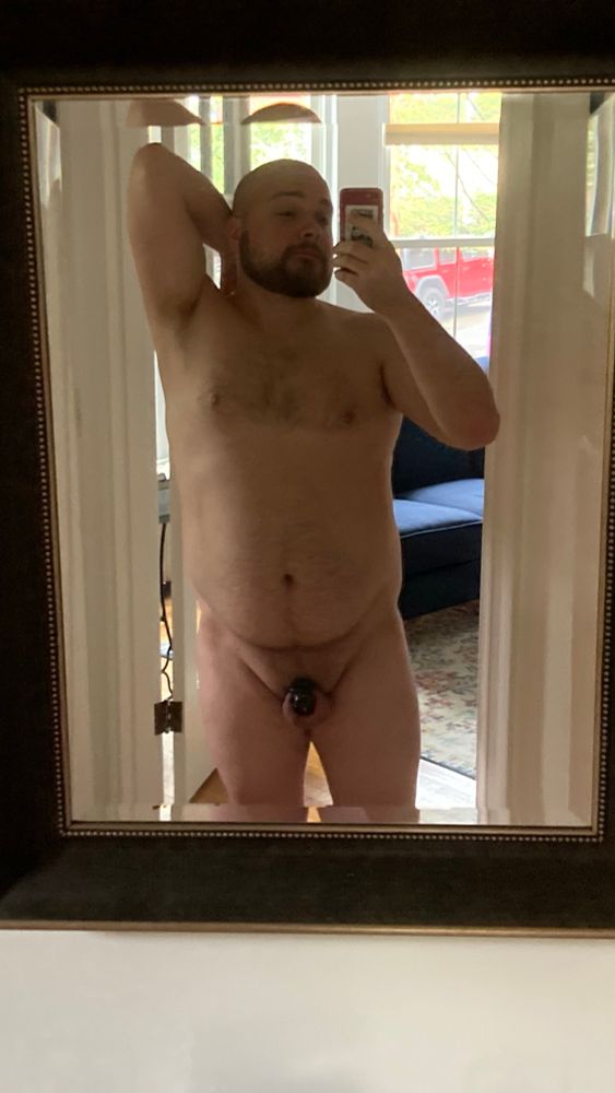 The artist, nude except for a cage, with gentle sunlight filtering through the window. #locked 