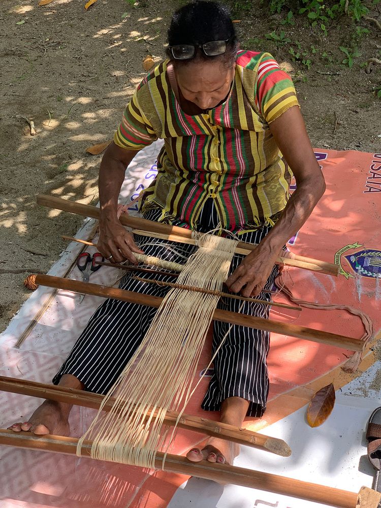weaving palm fiber with a foot-braced loom