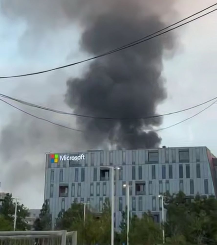 Column of smoke rising behind a Microsoft office building in Beersheba from an Iranian missile strike.