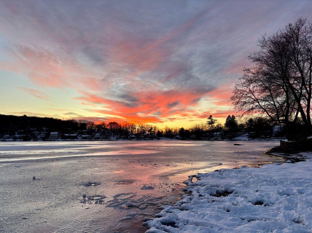 Semi frozen lake with sunset