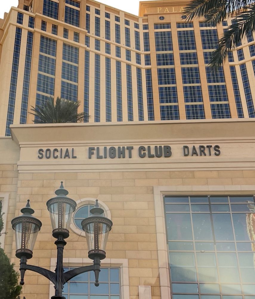 Text on side of hotel that reads “social FLIGHT CLUB darts”, with emphasis on FLIGHT CLUB, whatever that means 