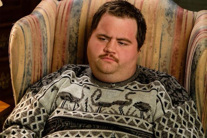 A stunning photo of Paul Walter Hauser in a charming flamingo sweater. If he ever said he was disappointed in me, I would die.