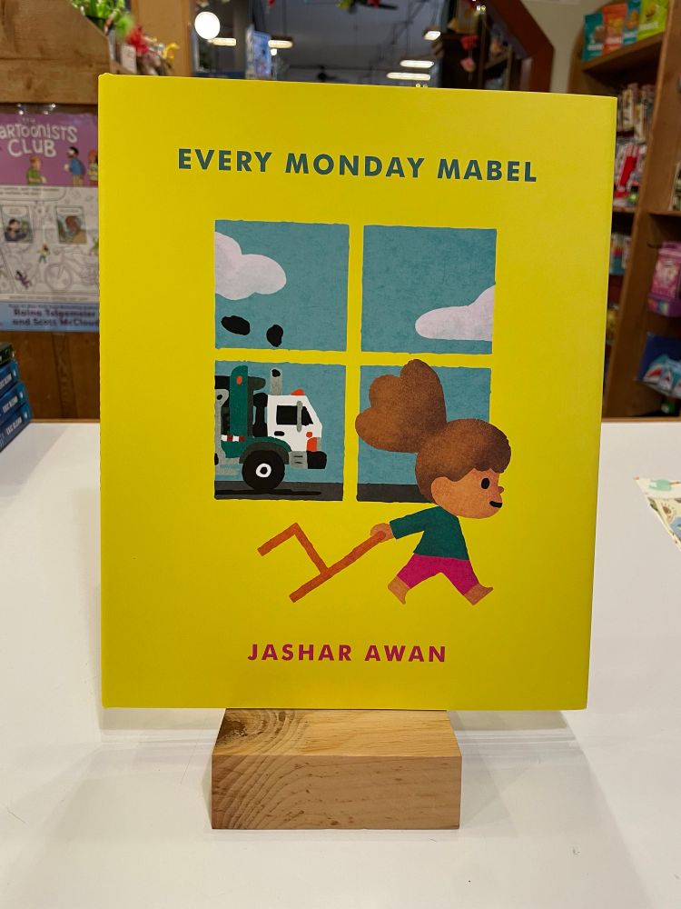 Cover of Every Monday Mabel by Jashar Awan. Shows a young girl dragging a chair across the cover in front of a window showing a garbage truck. 
