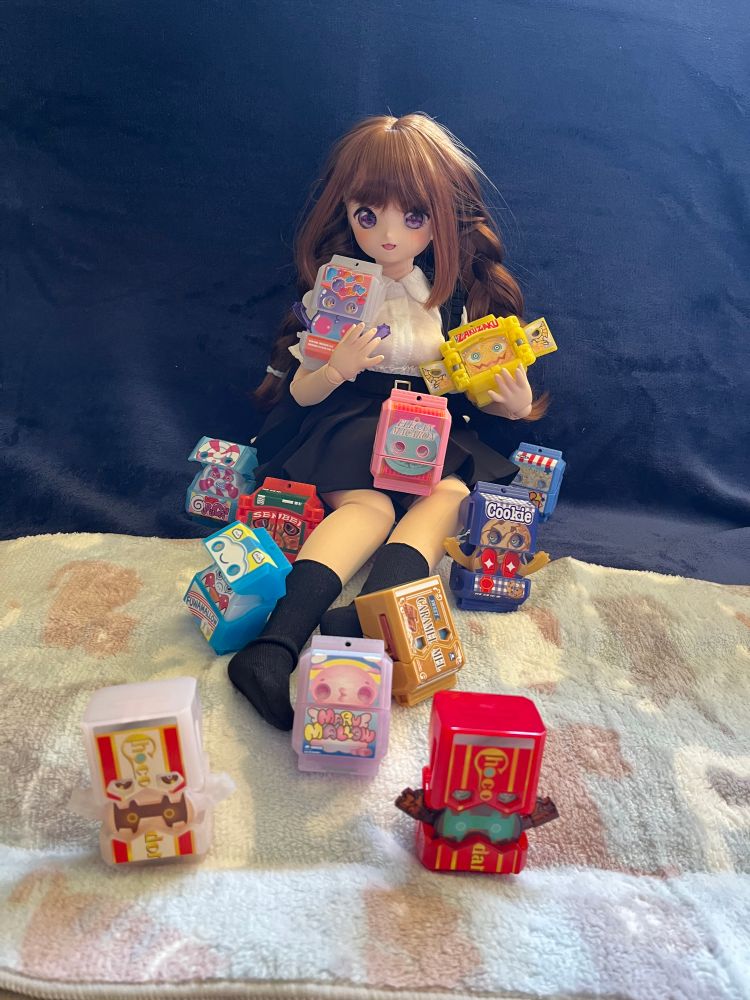 A very cute Mini Dollfie Dream doll with a bunch of Gochizo from Kamen Rider Gavv.