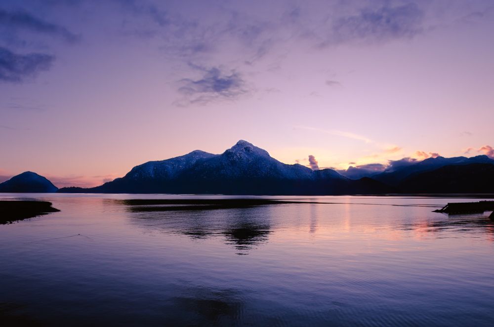 View of the mountains in Canada across a lake at sunset