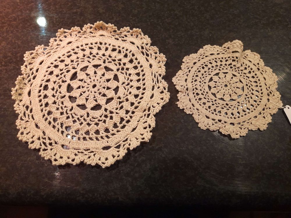 Two crochet doilies. One is an antique piece that was thrifted from an antique store. The other is a recreation of the pattern, done in larger thread, in the hopes of preserving a pattern that might be otherwise lost. It's the first pass, so there will need to be corrections, and as of now unblocked (the edges are curing up).