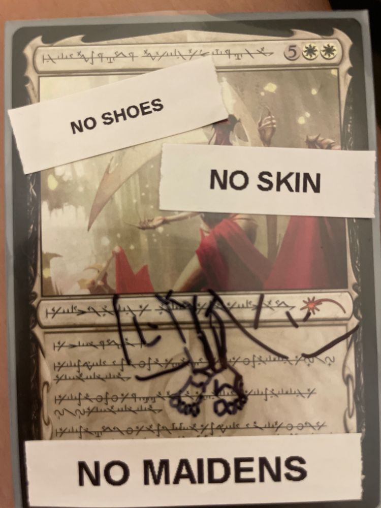 Another card, Elesh Norn, Grand Cenobite, vandalized to say "No shoes, no skin, no maidens" with bare feet poorly drawn extended from the card art