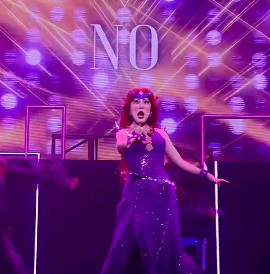 Queen Beryl from one of the latest live myu with NO in big letters behind her on a screen