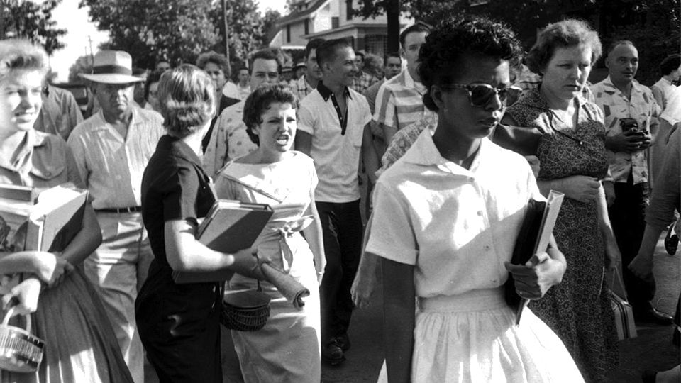Photo of Elizabeth Eckford walking into Little Rock Central High School on Sept. 4th, 1957, taken by Arkansas Democrat Photographer Will Counts. The photo also shows the mob harassing Eckford. In the center of the frame among the crowd is seen student Hazel Bryan Massery, shouting "Go home, (n-word)! Go back to Africa” at Eckford.