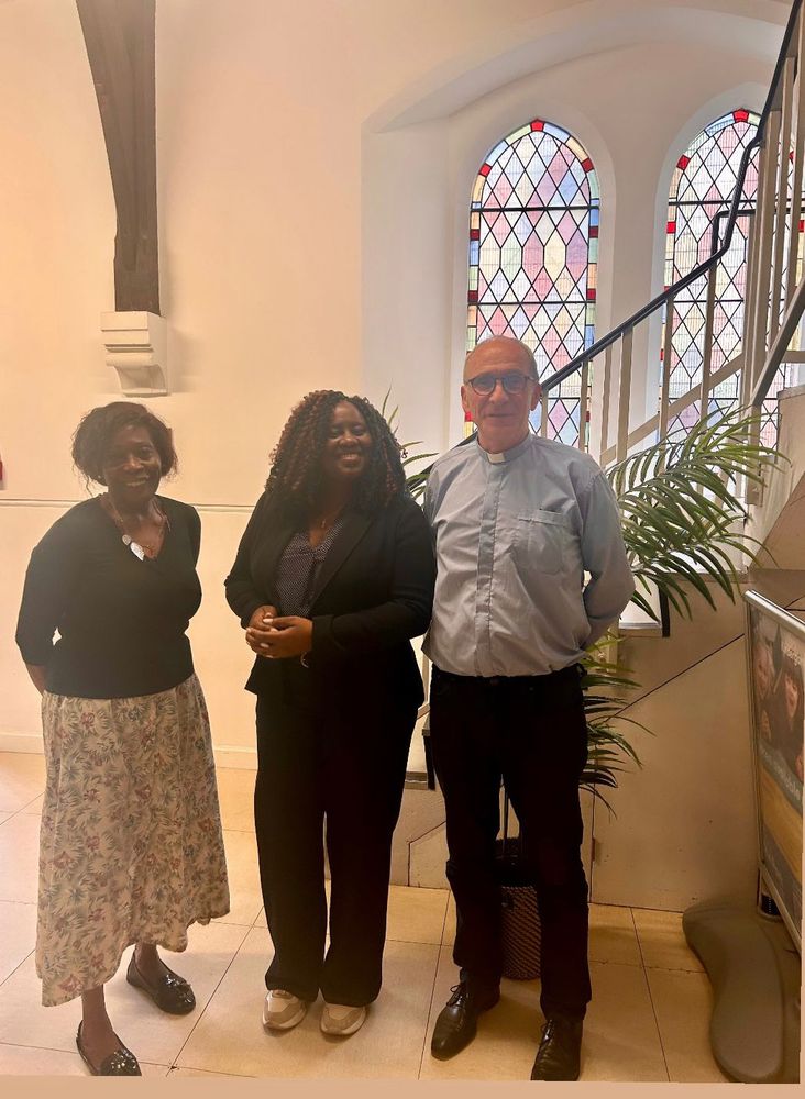 Marsha with the priest and a church worker