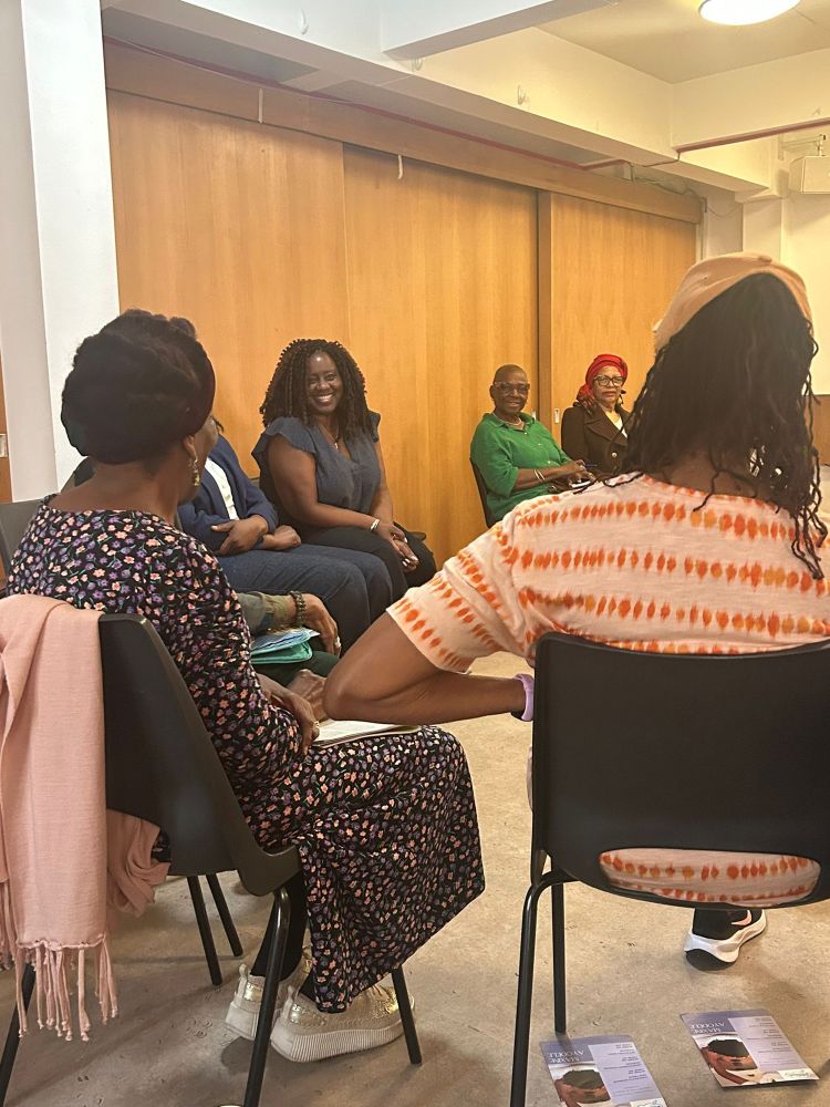 Marsha sat in a group speaking 