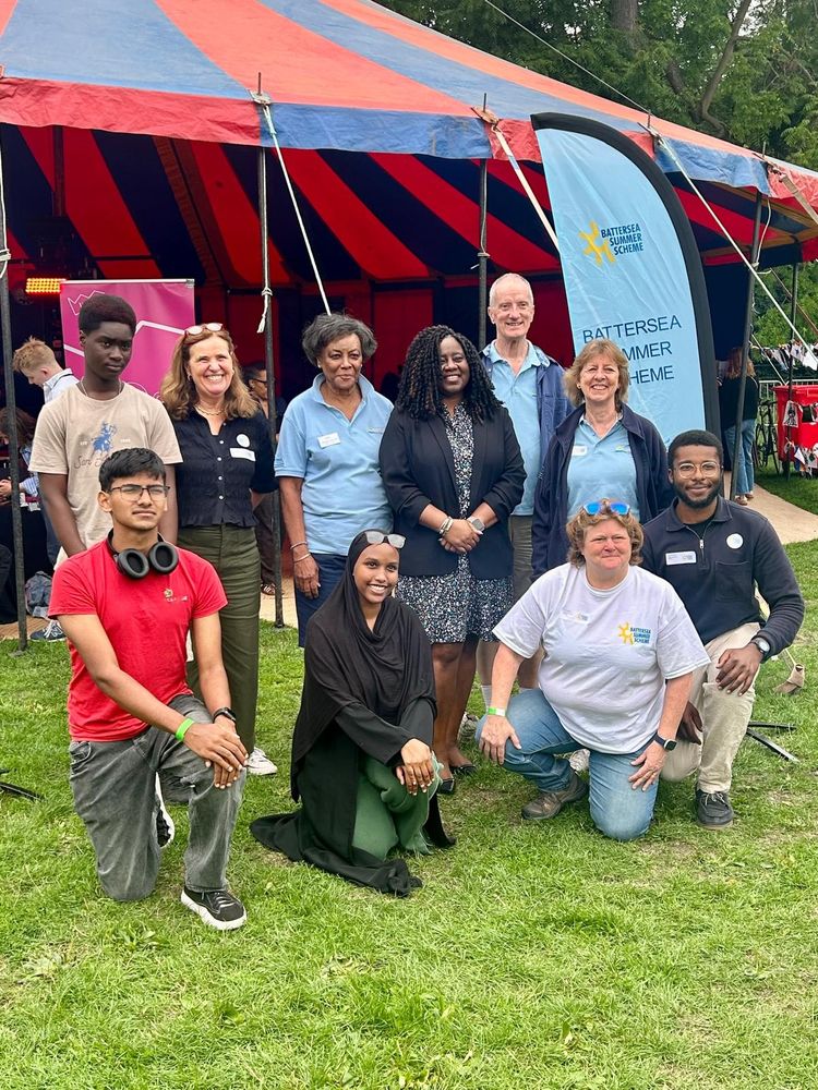 Marsha with a group of volunteers outside a tent