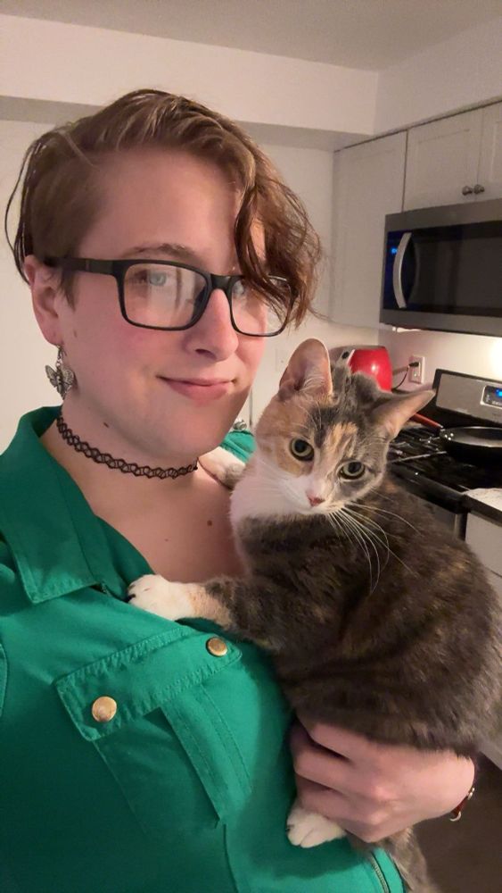 Charlie Mev holding her cat.