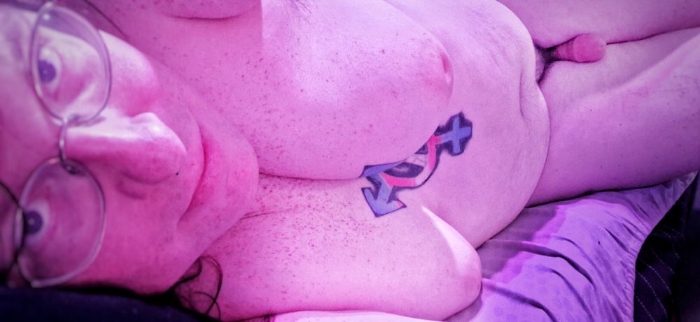 I'm laying in bed after a shower, nude, showing my tits and my girl cock, soft.