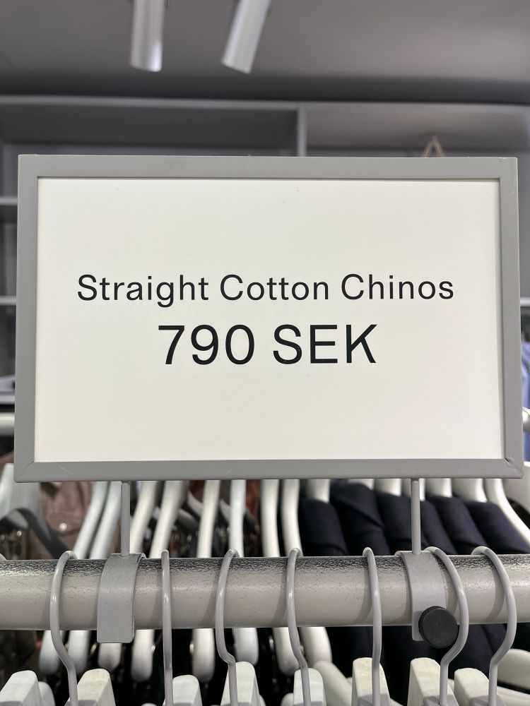 A sign reading Straight Cotton Chinos with a price in Swedish Krona of 790 SEK 