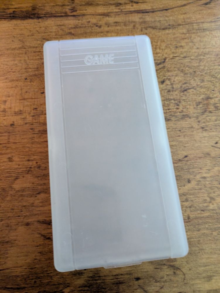 An extra long case for a bootleg Game Boy cartridge. The case seems more similar in design to a Sega Game Gear case than a Nintendo Game Boy case.