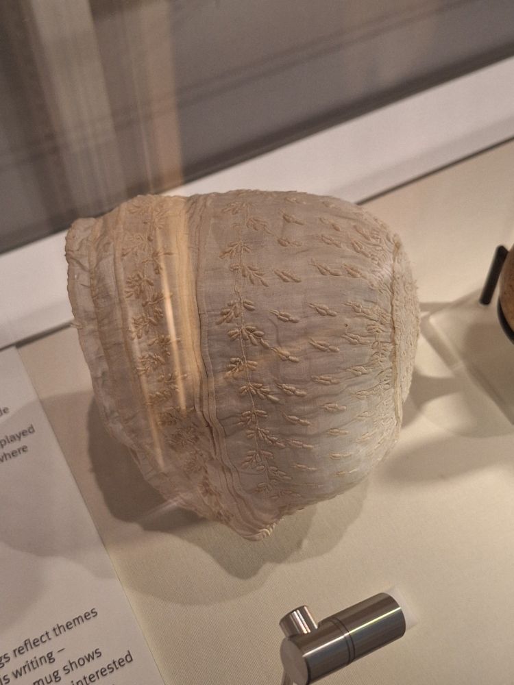 Thomas Hardy's christening bonnet, a white baby bonnet intricately embroidered.