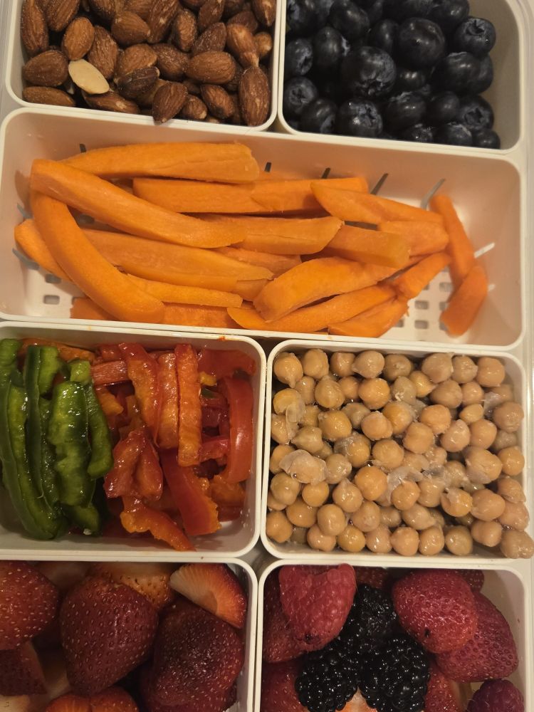 Carrots, almonds, strawberries, chick peas in a divided sectional snack box