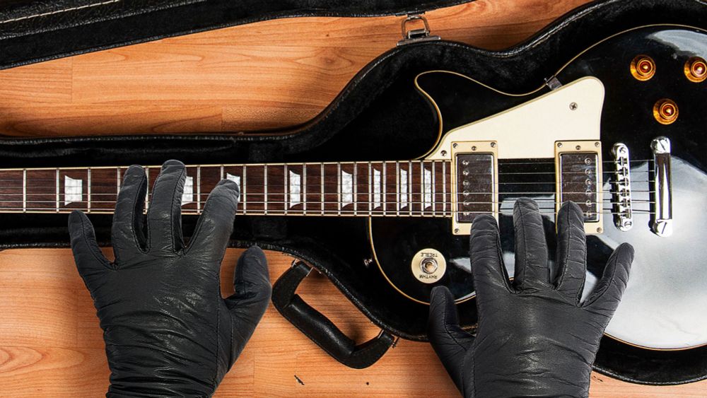 Hit Man Opens Guitar Case Concealing Guitar He Going To Beat Target’s Ass With