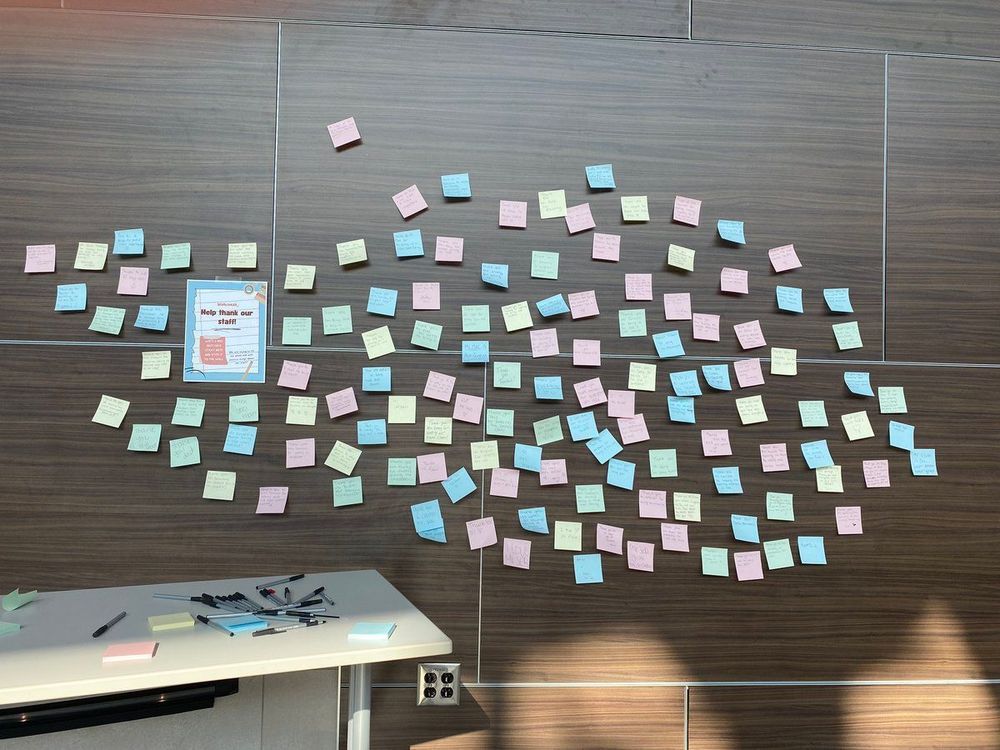 Picture of a bunch of Post-it notes on a wall with positive messages students wrote about their teachers.