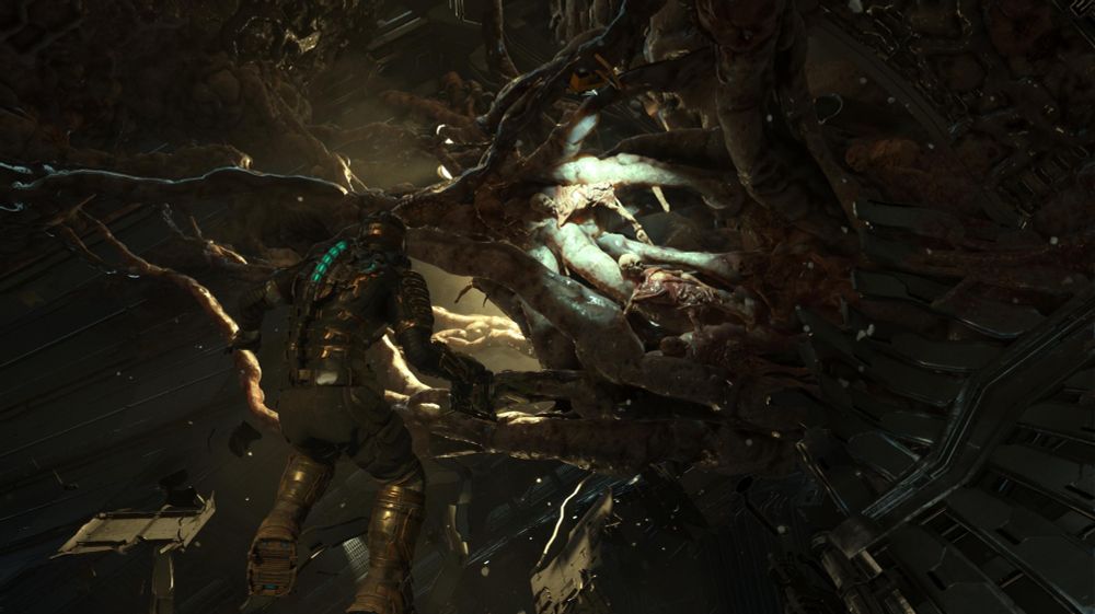 A screenshot from Dead Space (Remake) where protagonist Isaac Clarke is floating in zero gravity, shining his flashlight at a web of fleshy tendrils that criss-cross the environment in front of him. There are human bodies and limbs visible in the tendrils.