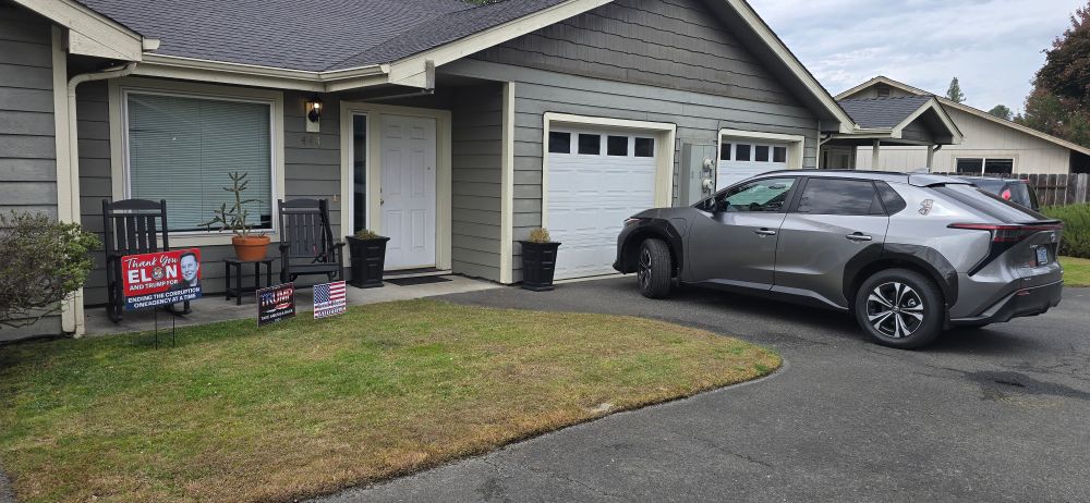 Some Republicans house that has a 45-47 magnet on the car, a God Bless America yard sign, a trump take back America sign, and a thank you Elon and Trump for uncovering the corruption sign.