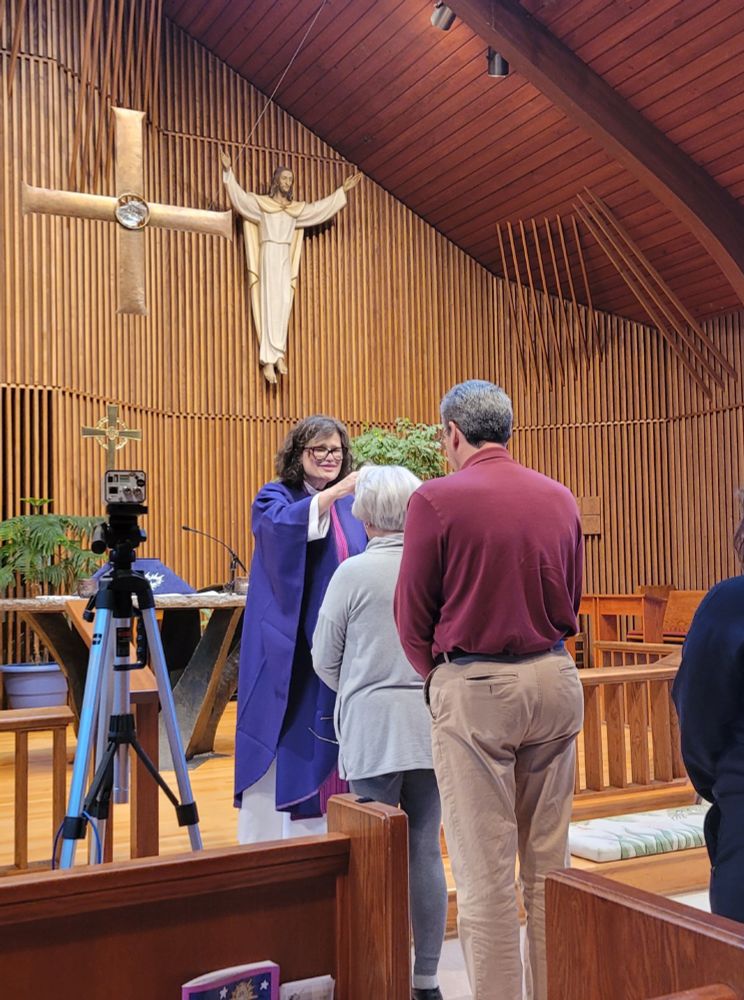 Rev. Amy imposing ashes on a community member for Ash Wednesday services.