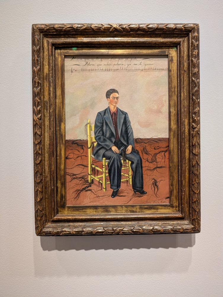 A picture of the painting titled "Self Portrait With Cropped Hair" by Frida Kahlo.
