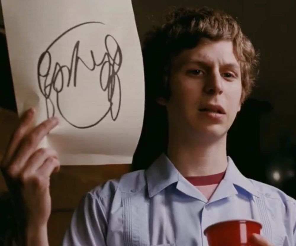 Scott Pilgrim holding a piece of paper with a crudely drawn Ramona Flowers