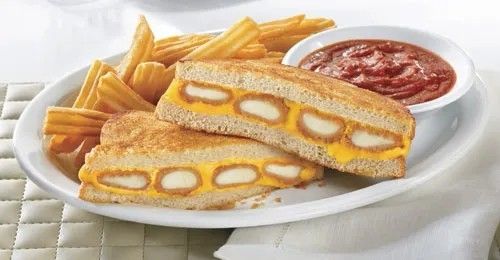 mozzarella sticks grilled cheese sandwich served with a side of marinara for dipping. also, fries.
