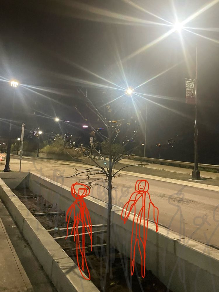 Stick figures standing inside deep, deep concrete planters recessed in the sidewalk.