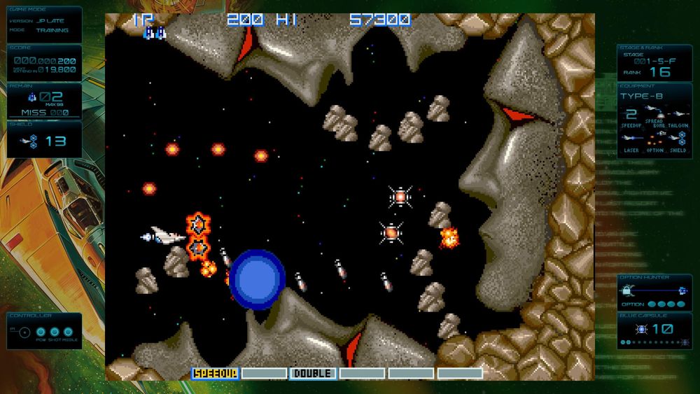 Gradius Origins (2D space shooter) screenshot showing the player ship, some missiles, Moai heads, rocks and a couple powerups with the emulation wrapper bordering the screen
