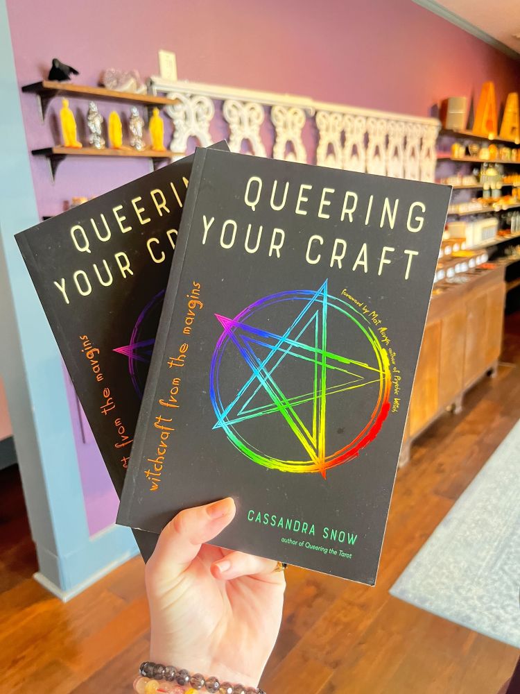 Two copies of the book Queering Your Craft: Witchcraft From the Margins by Cassandra Snow. Located at Déjà Vu Esoterica, a metaphysical shop in San Antonio, TX