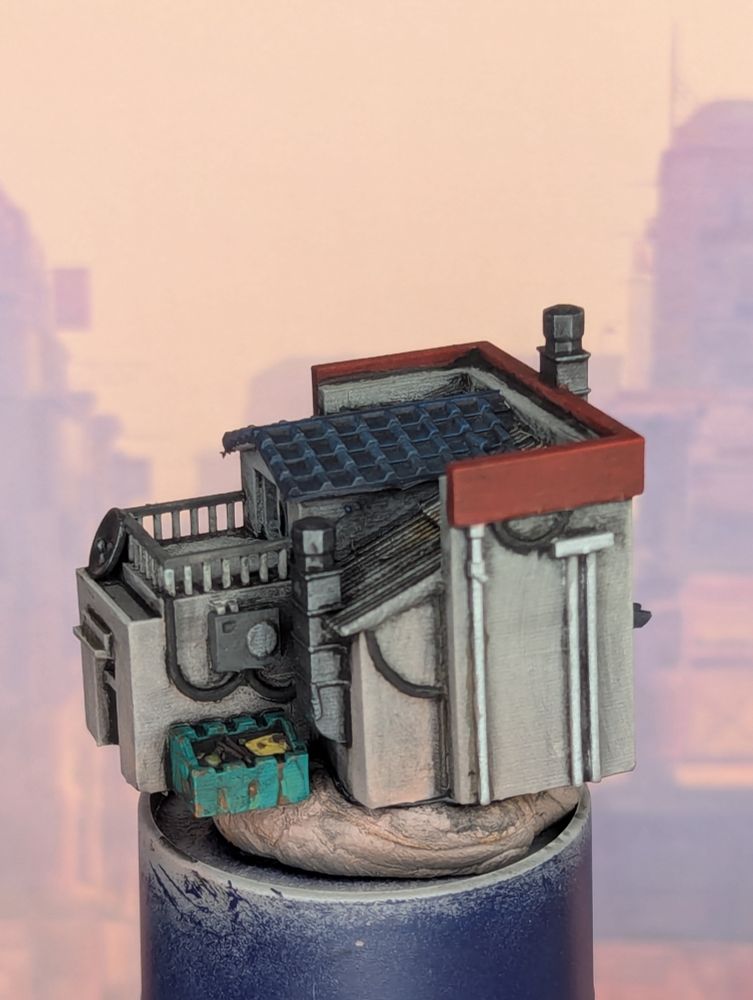 A painted 6mm scale miniature of a ramen shop, viewed from the left side. A dumpster rusts behind the shop.