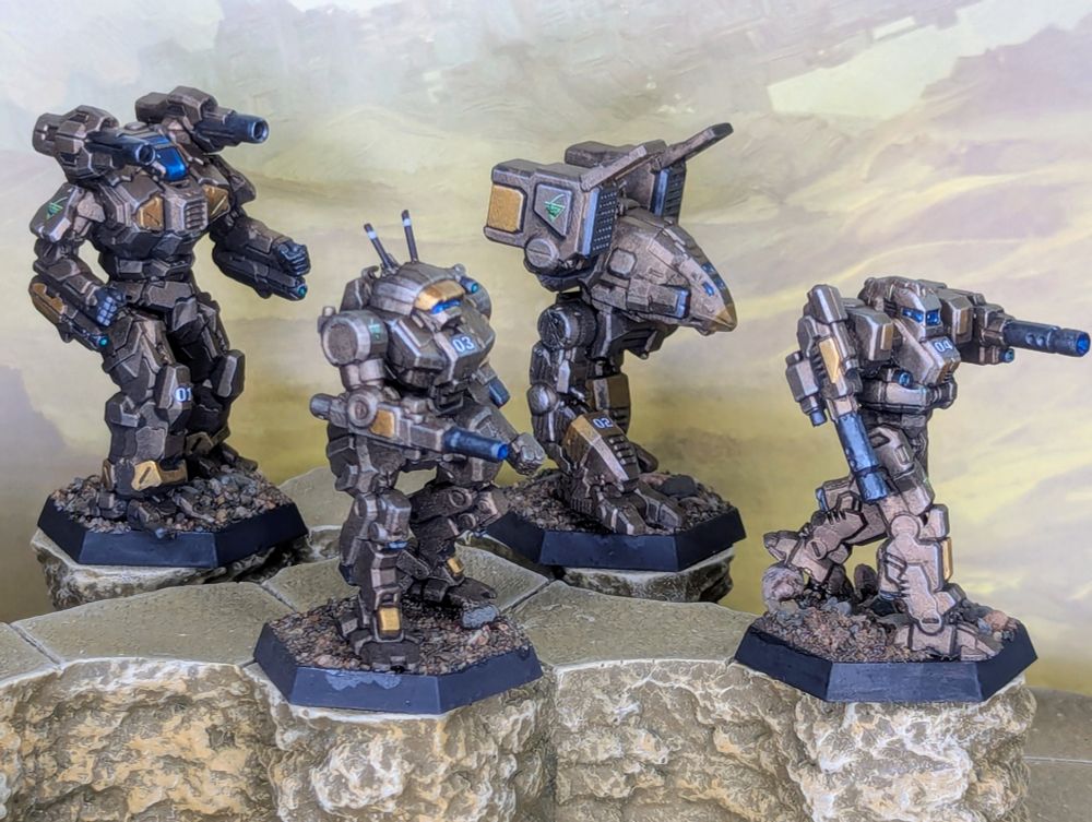 Four painted mecha miniatures for Battletech, painted bronze and gold for the Tau Ceti Lancers. From left to right, a Tian-zong, Vindicator, Catapult, and Blackjack.
