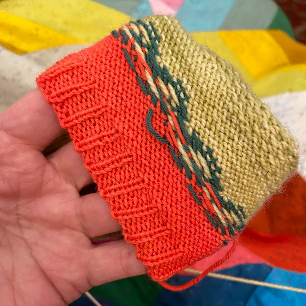 Wrong side of a Fair Isle knit socks with cuff.