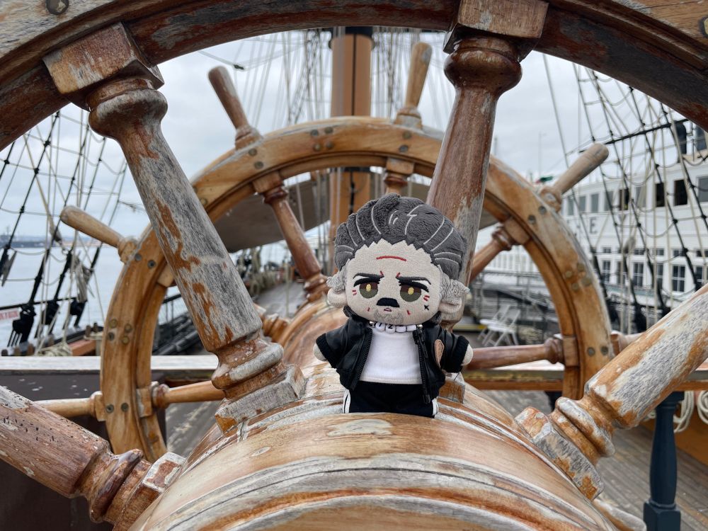 15cm Izzy doll by Rights on a ship's wheel