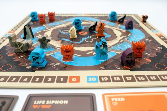 A photo of Life Siphon, showing a board and screen-printed wooden pieces representing imps, liches, and death knights