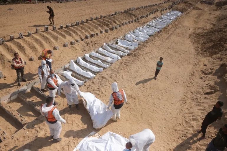 Health and civilian workers conduct a mass burial of Palestinians at a cemetery in Khan Younis, in the southern Gaza Strip, on November 10, 2025 [File: Bashar Taleb /AFP]