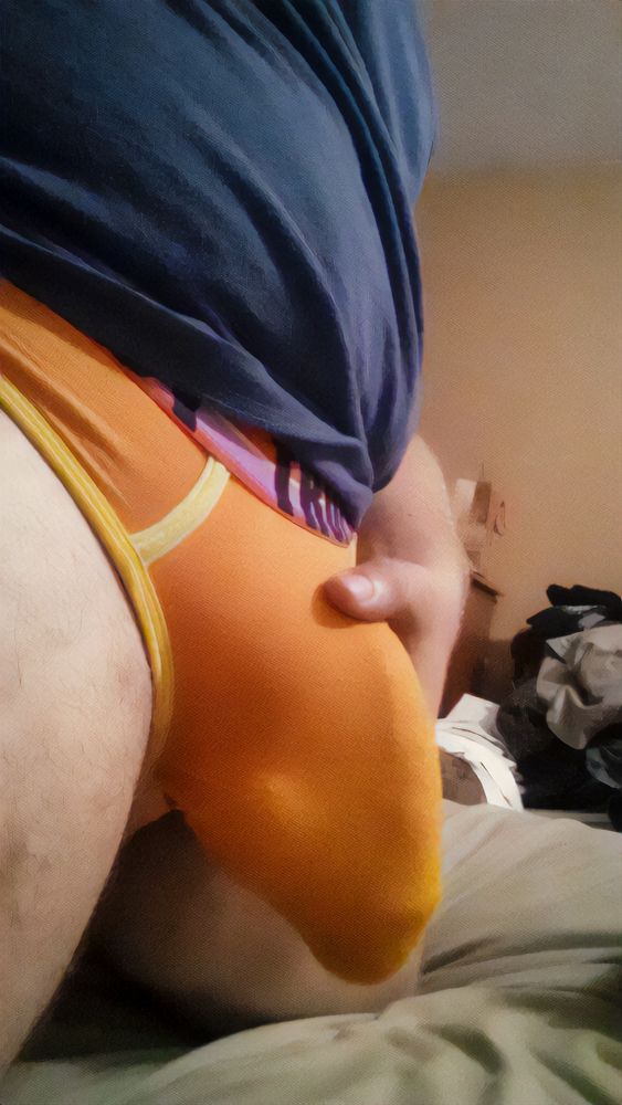A profile view of my bulge in orange briefs. It highlights a vein that I particularly enjoy