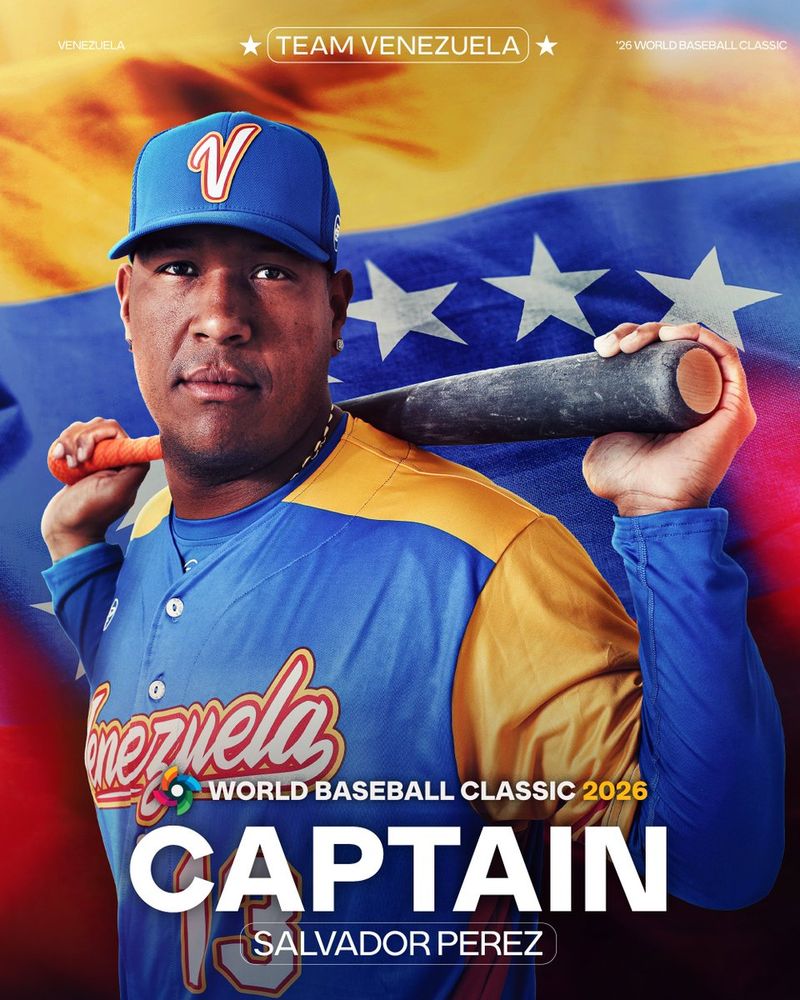 World Baseball Classic 2026
Team Venezuela
Captain
Salvador Perez
Pictured: A cutout of Salvador Perez resting a bat along his shoulders while posing for a photo. He is wearing a blue and yellow Team Venezuela jersey and a blue cap. The Venezuela flag is pictured in the background. 