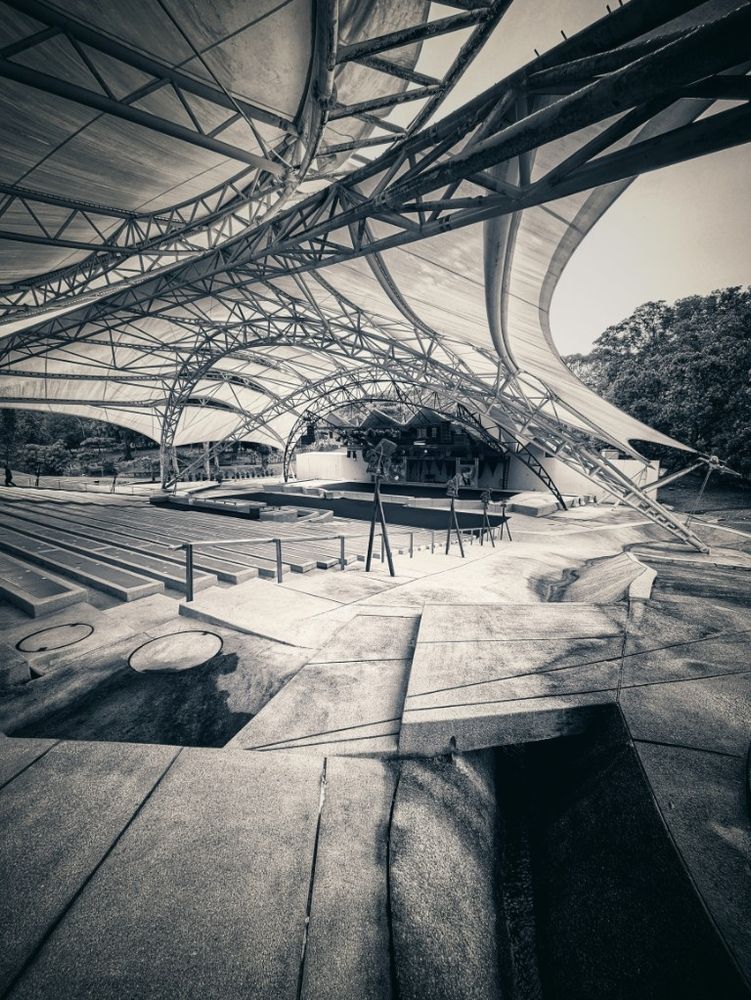Seemingly bio mechanical inspired scaffolding stretches over a large outdoor auditorium protecting the audience from the harsh Malaysian elements and enhancing acoustics
