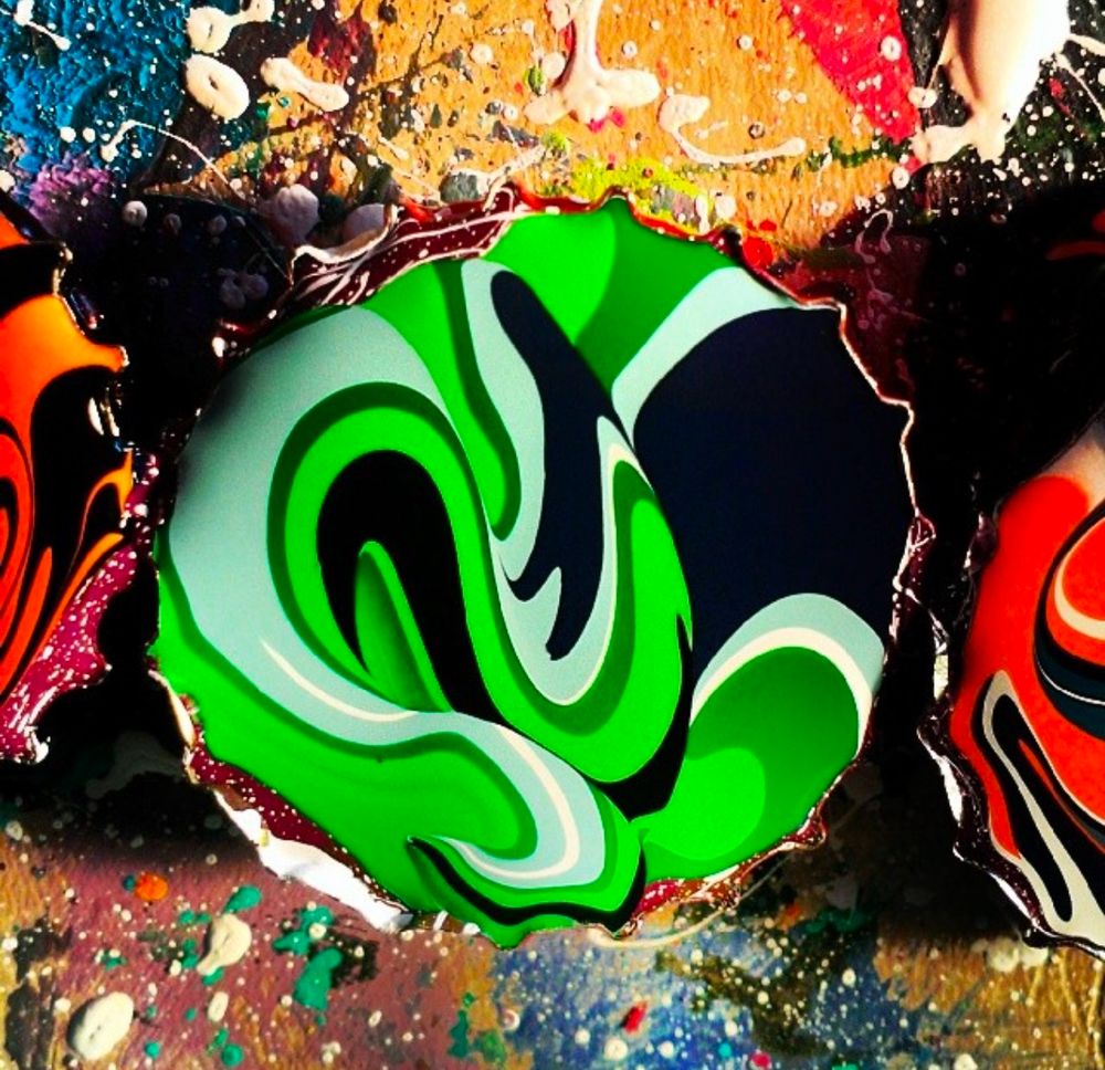 Multi-color acrylic paint in a bottle cap.