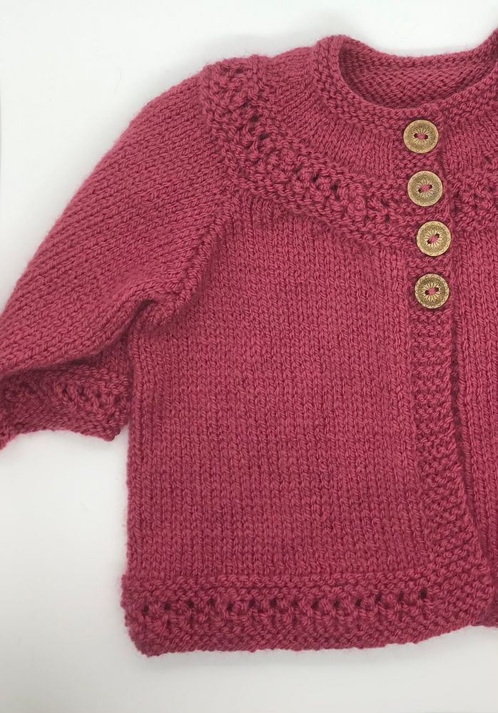 Dark pink baby cardigan fastened with 4 wooden buttons