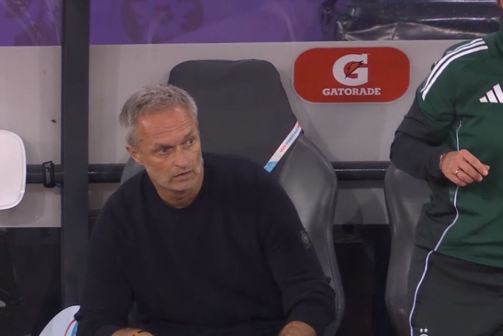 The coach of the German woman’s football team, sitting in his coaching chair looking like a second tier Jose Murinho