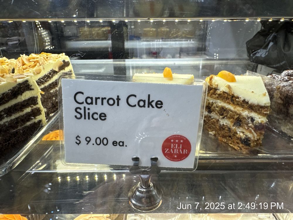 A picture of a piece of carrot cake with a price of $9.00.